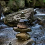 Image of rocks balanced in a river to illustrate post