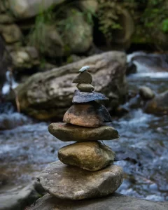 Image of rocks balanced in a river to illustrate post