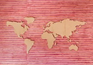 Image of the shapes of large land masses of the world placed on a pink background to illustrate post