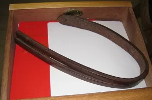 An image of a 'tawse' (school strap) for punishing children in school in Scotland until 1975, to illustrate post