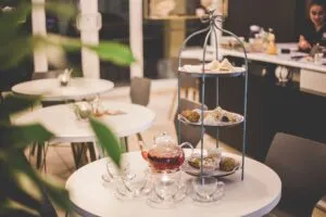 Image of tearoom containing tables and layered cake stand to illustrate post