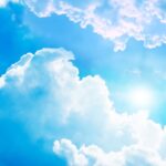 Image of sunshine in a blue sky with a few white clouds to illustrate post