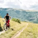 Image of a woman on a bike on top of a mountain to illustrate post