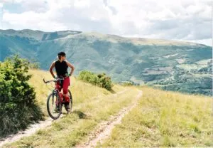 Image of a woman on a bike on top of a mountain to illustrate post