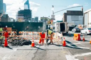 Image of construction personnel working on the road to illustrate post