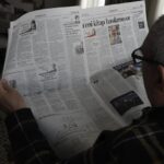 Image of person reading a newspaper to illustrate post