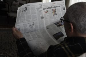 Image of person reading a newspaper to illustrate post