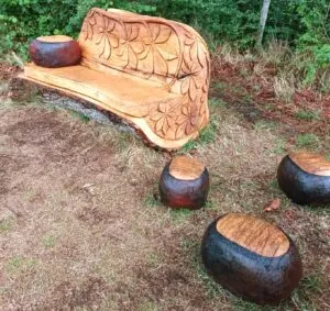 Image of bench and huge scattered 'conkers' carved from trees, and used to illustrate post