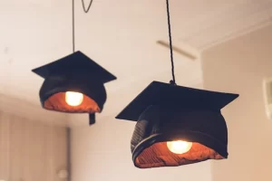 Image of graduation caps being used as lightshades to illustrate post