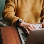 Image of a person typing on a laptop to illustrate post