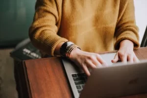 Image of a person typing on a laptop to illustrate post