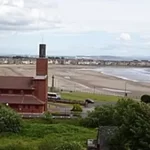 Image of a beach from the vantage point of a hill to illustrate post