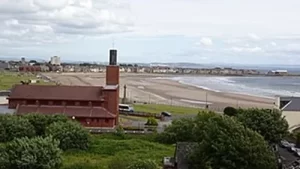 Image of a beach from the vantage point of a hill to illustrate post