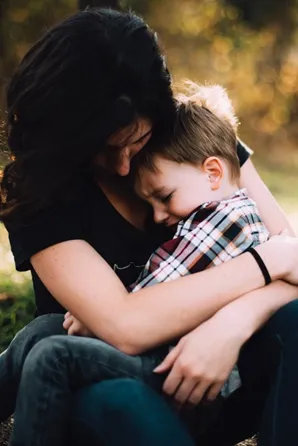 Image of a woman cuddling a boy to illustrate post