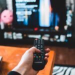 Image of person using remote control to watch TV, used to illustrate post