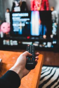 Image of person using remote control to watch TV, used to illustrate post