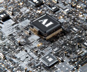 Image of very large chip in the middle of a circuit board, with the letters 'AI' printed on it, to illustrate post.